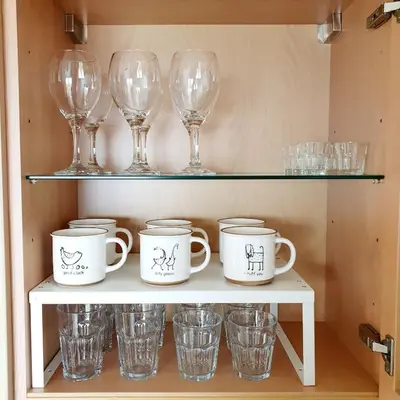 a shelf with wine glasses and cups on it at Oceanview Getaway in Caniço