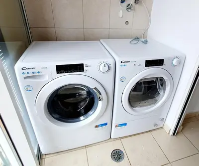 two washing machines sitting next to each other in a bathroom at Oceanview Getaway in Caniço