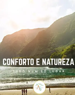 a sign on a beach with mountains in the background at Enjoy Madeira 1 in Caniço