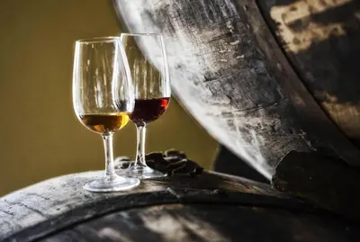 two wine glasses sitting on top of a barrel at Enjoy Madeira 1 in Caniço