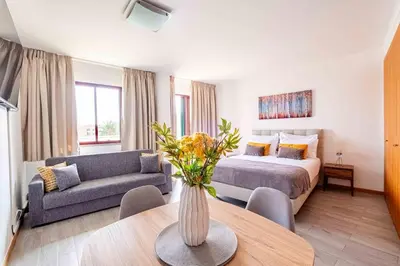 a living room with a bed and a couch at Enjoy Madeira 1 in Caniço