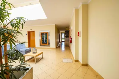 a living room with a couch and a table at Enjoy Madeira 1 in Caniço