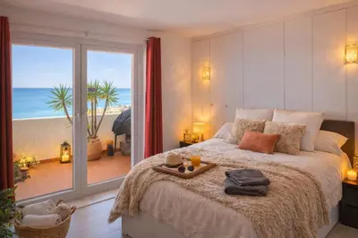 a bedroom with a bed with a view of the beach at Bliss Luz Horizon - Panoramic Sea View - 50m to Beach - Central Praia da Luz - Walk distance to Everywhere in Luz