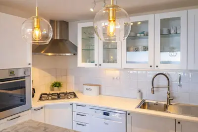 a kitchen with white cabinets and a sink at Bliss Luz Horizon - Panoramic Sea View - 50m to Beach - Central Praia da Luz - Walk distance to Everywhere in Luz
