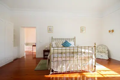 a bedroom with a metal bed in a room at Quinta das Malvas - Quinta de Santa Luzia in Funchal
