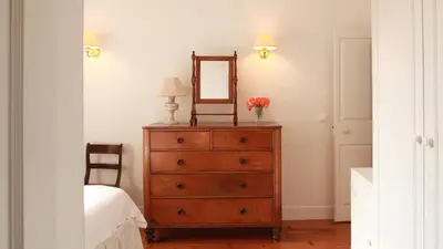 a bedroom with a dresser with a mirror on it at Quinta das Malvas - Quinta de Santa Luzia in Funchal