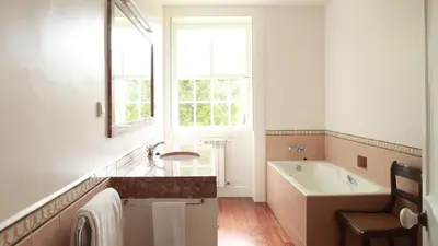 a bathroom with a tub and a sink and a window at Quinta das Malvas - Quinta de Santa Luzia in Funchal