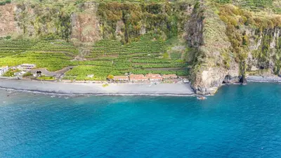 an aerial view of a beach next to the ocean at Ferreira's Retreat in Ponta do Sol