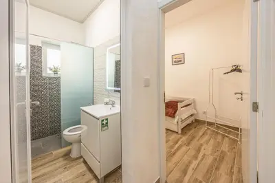 a white bathroom with a toilet and a shower at Ferreira's Retreat in Ponta do Sol