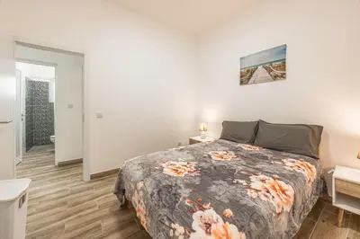 a bedroom with a bed and a bathroom at Ferreira's Retreat in Ponta do Sol