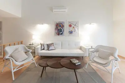 a living room with a couch and two chairs and a table at Villas T3 com Jardim Vila Sagres in Sagres