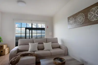a living room with a couch and a window at Ozeanica Heights by LovelyStay in Gaula