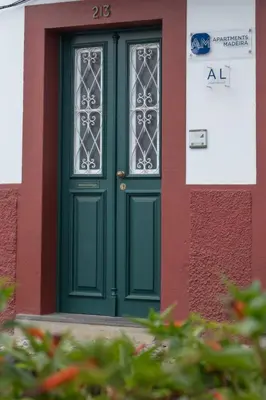 a green door on the side of a building at Apartments Madeira Santa Maria in Funchal