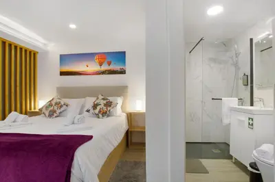 a hotel room with a bed and a bathroom at Litlle Zen House in Santana