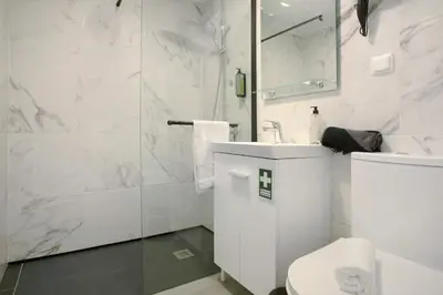 a white bathroom with a toilet and a sink at Litlle Zen House in Santana