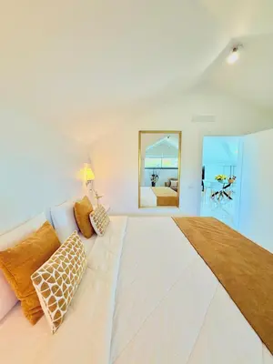 a large white bedroom with a large bed at Refúgio do Vale Verde in Ponta do Sol