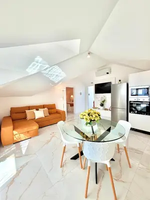 a living room with a glass table and a couch at Refúgio do Vale Verde in Ponta do Sol