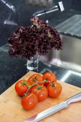 a bunch of tomatoes sitting on a cutting board at Apartamento Costa in Funchal