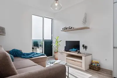a living room with a couch and a tv at Apartamento Costa in Funchal