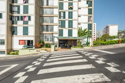 an empty street in front of a tall building at Apartamento Costa in Funchal
