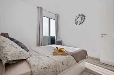 a bedroom with a bed with a tray of fruit on it at Apartamento Costa in Funchal