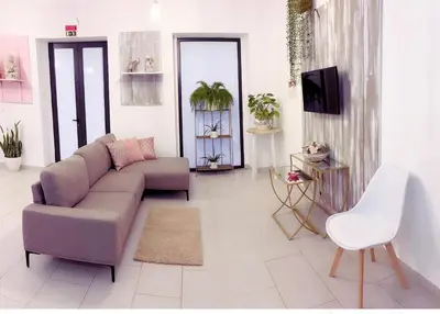 a living room with a couch and a tv at ALc in Ribeira Brava