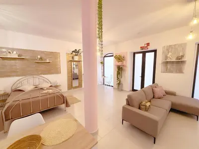 a living room with a bed and a couch at ALc in Ribeira Brava