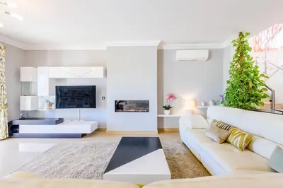 a living room with a white couch and a plant at The White House in Lagos