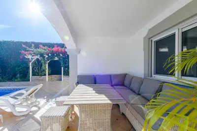 a living room with a purple couch and a table at The White House in Lagos