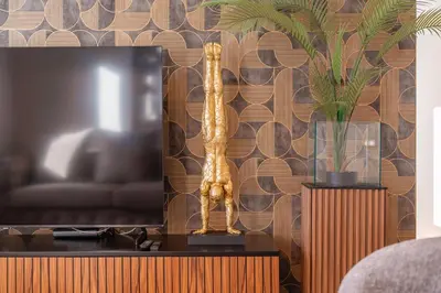 a living room with a tv and a statue on a table at Lux House - free park- WiFi - Sea View in Funchal