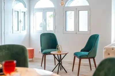 a room with two green chairs and a table at Lux House - free park- WiFi - Sea View in Funchal