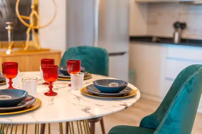 a table with plates and wine glasses on it at Lux House - free park- WiFi - Sea View in Funchal