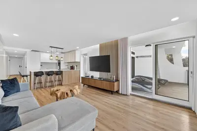 a kitchen with wooden cabinets and a stainless steel refrigerator at Sunset Atlantic Gardens Apartments 408 in Funchal