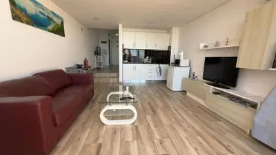 a living room with a couch and a coffee table at Sunny Pearl Apartment in Caniço