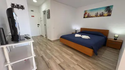 a bedroom with a bed and a flat screen tv at Sunny Pearl Apartment in Caniço
