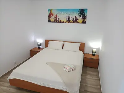 a bedroom with a large bed with two night stands at Sunny Pearl Apartment in Caniço