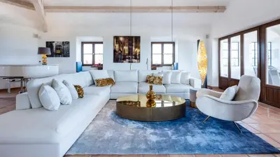 a living room with a white couch and a table at Luxury Villa by the Sea with Ocean Views in Luz
