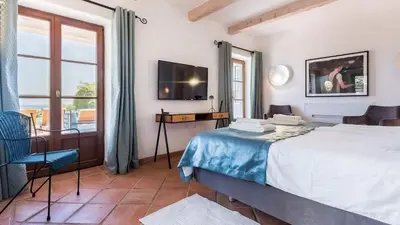 a bedroom with a large bed and a television at Luxury Villa by the Sea with Ocean Views in Luz