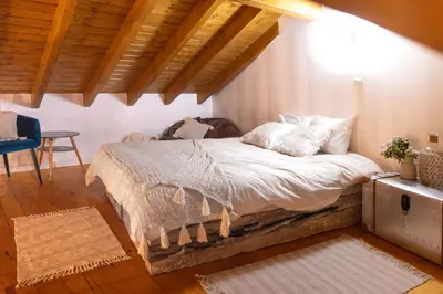 a bed in a bedroom with a wooden ceiling at Chalet du Solei- V022 in Salema