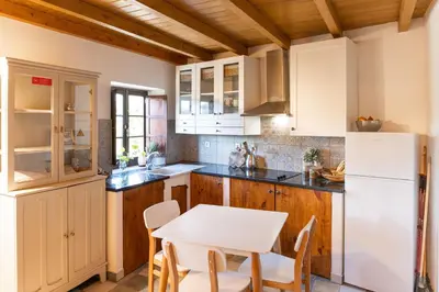 a kitchen with a table and a white refrigerator at Chalet du Solei- V022 in Salema