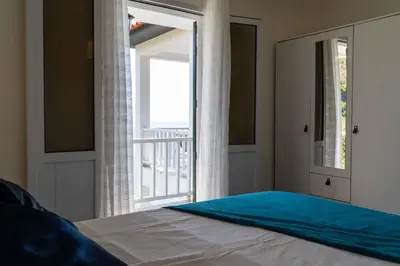 a bedroom with a bed and a sliding glass door at Villa Irene in Funchal