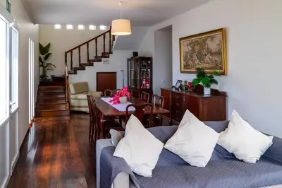 a living room with a couch and a dining room at Villa Irene in Funchal