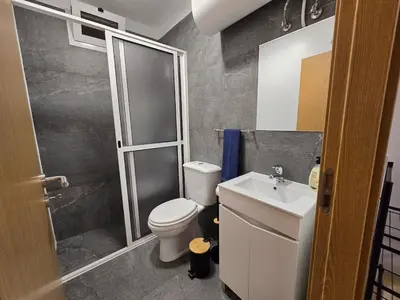 a bathroom with a toilet and a sink and a shower at Autonomia House II in Câmara de Lobos