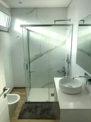a bathroom with a glass shower and a sink at Vila Da Luz Calheta in Estreito da Calheta