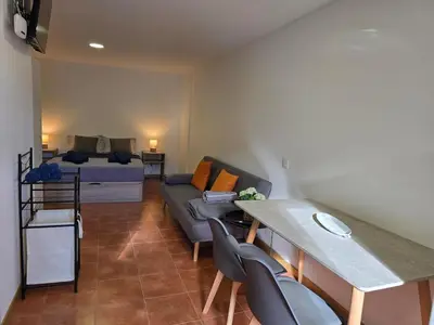 a living room with a couch and a table at Autonomia House III in Câmara de Lobos