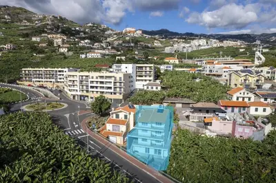 a view of a city with houses and a road at Autonomia House III in Câmara de Lobos