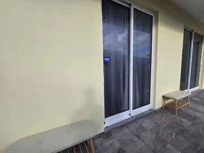 a room with a window with a bench and a chair at Autonomia House III in Câmara de Lobos