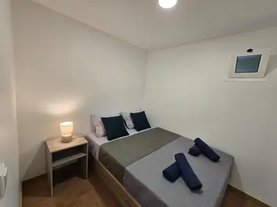 a bedroom with a bed with two blue pillows at Autonomia House IV in Câmara de Lobos