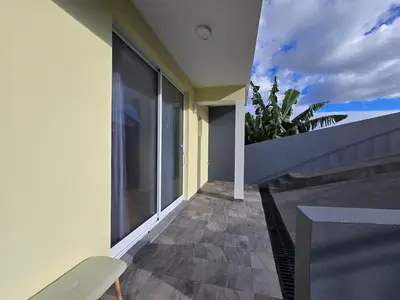 a balcony of a house with a view of the sky at Autonomia House IV in Câmara de Lobos