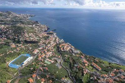 an aerial view of a city next to the ocean at Autonomia House IV in Câmara de Lobos